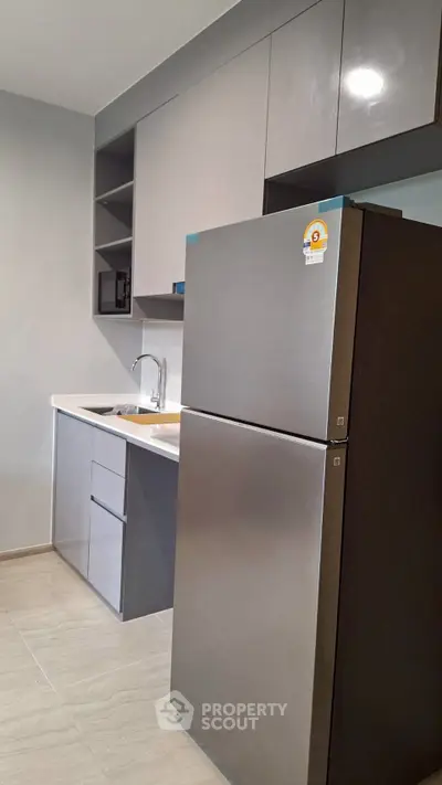 Modern kitchen with sleek cabinets and stainless steel fridge