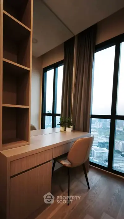 Modern study room with city view, featuring sleek wooden desk and comfortable chair.