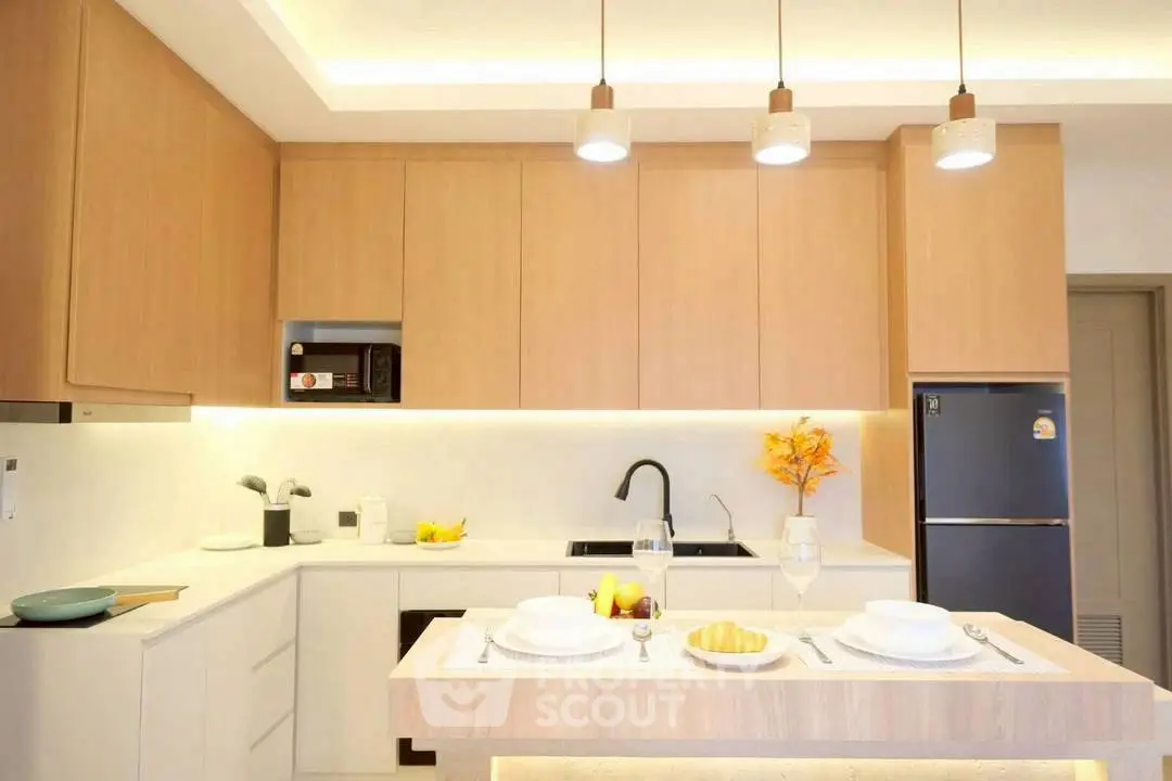 Modern kitchen with sleek cabinetry and stylish lighting