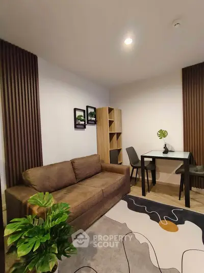 Stylish living room with modern decor, cozy sofa, and elegant dining area in a contemporary apartment.