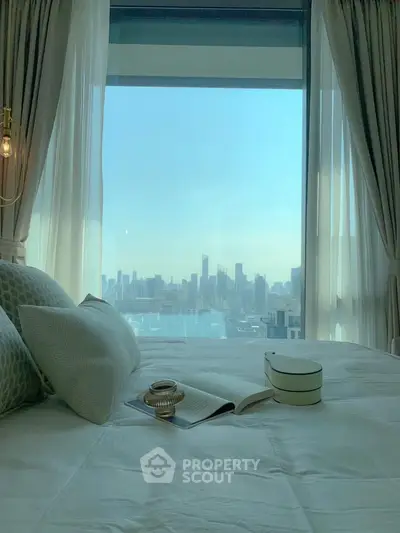 Luxurious bedroom with stunning city skyline view through large window.