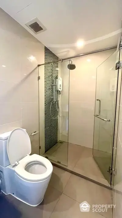 Modern bathroom with glass shower enclosure and sleek tile design