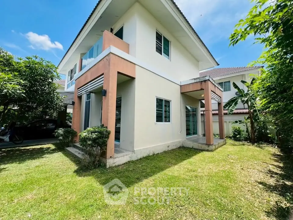 Charming two-story house with lush garden and modern architecture in a serene neighborhood.