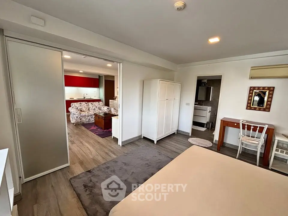 Spacious open-plan living area with modern decor and sliding doors in a stylish apartment.