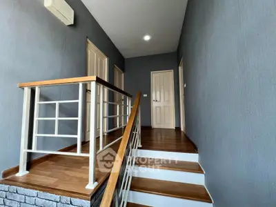 Modern staircase with wooden flooring and sleek railing design