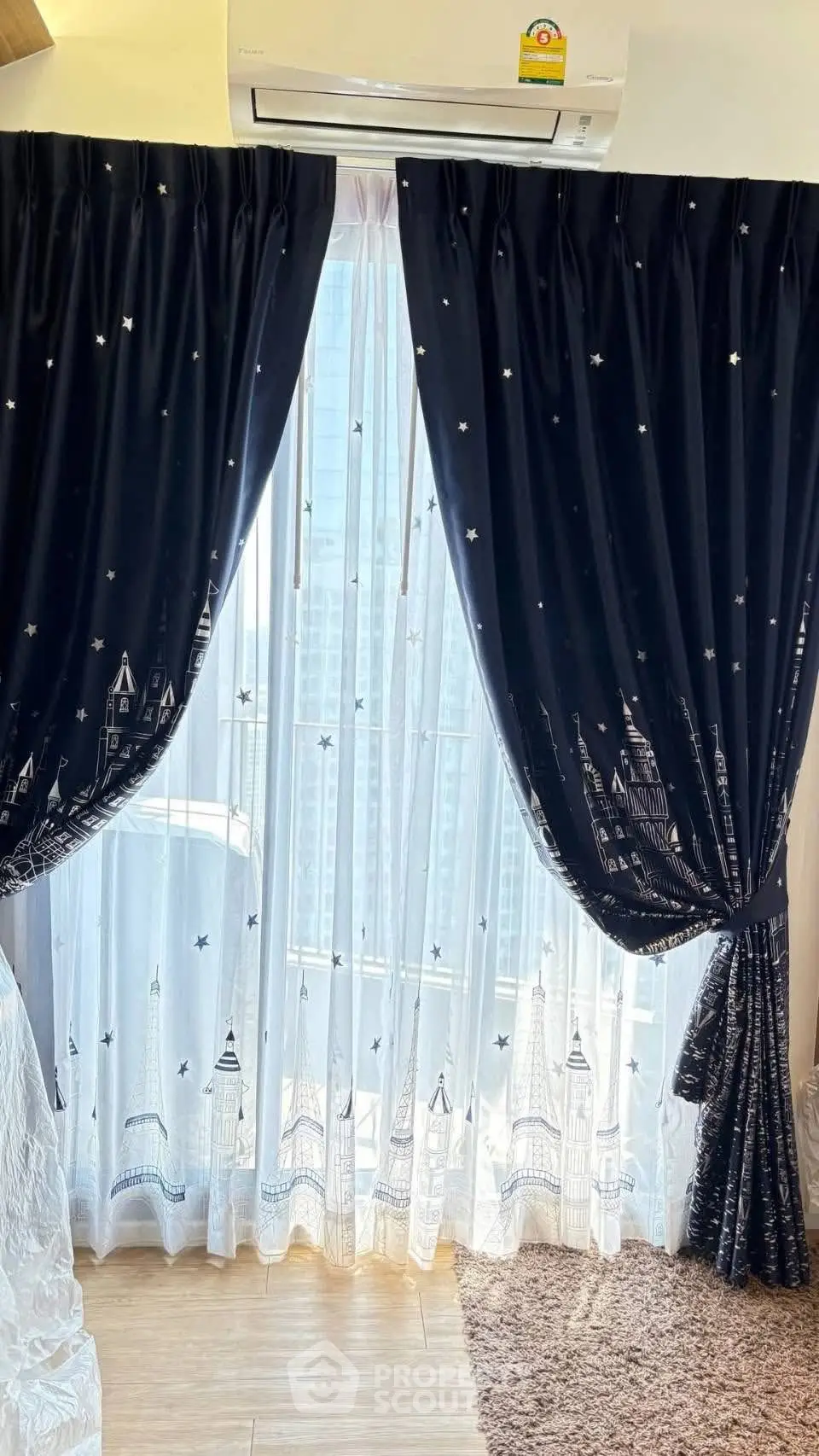 Elegant living room with starry curtains and city view