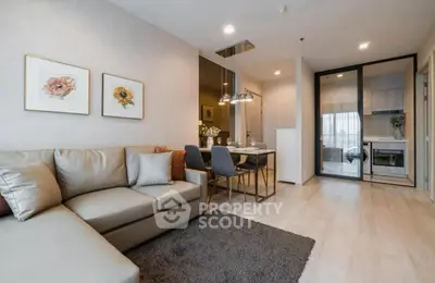 Modern living room with cozy sofa and dining area in open layout apartment.