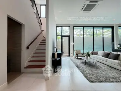 Spacious modern living room with large windows and stylish decor