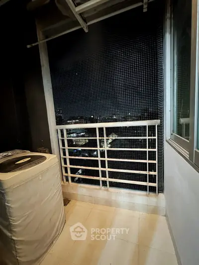 Cozy balcony with city view, perfect for relaxation and enjoying the night skyline.