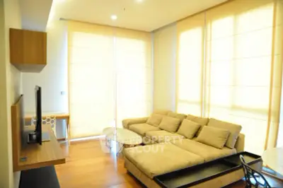 Spacious living room with modern decor and large windows for natural light.