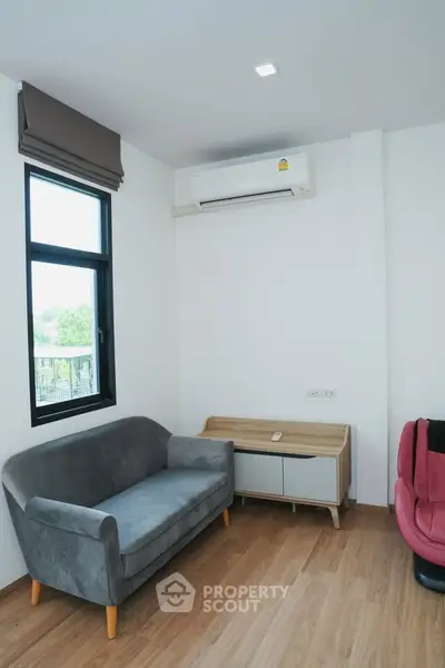 Modern living room with sleek sofa and air conditioning