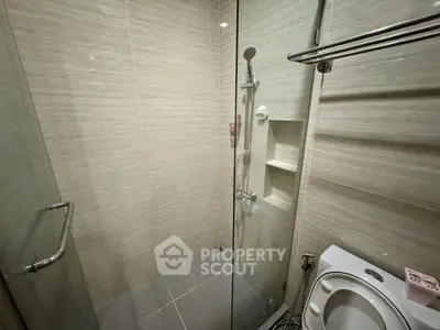 Modern bathroom with glass shower enclosure and sleek tile design