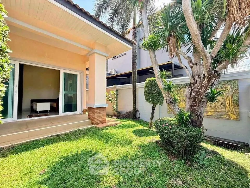 Charming garden view of a cozy home with lush greenery and inviting patio.