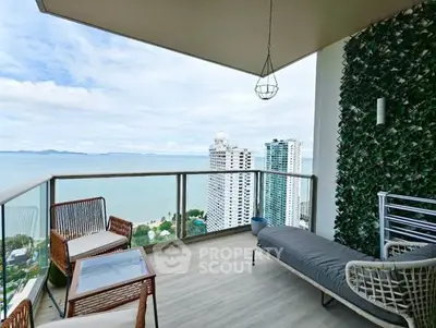 Stunning high-rise balcony with ocean view and modern outdoor furniture.