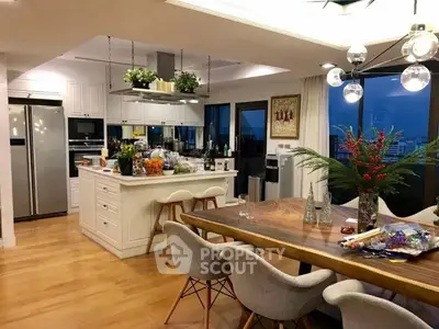 Luxurious open-layout kitchen with modern appliances and elegant dining area, perfect for entertaining.