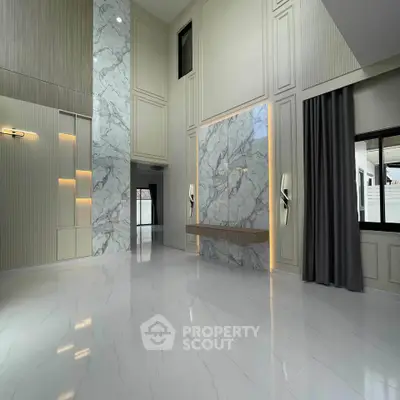 Luxurious modern living room with high ceilings and elegant marble accents.