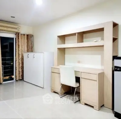 Modern study room with sleek desk and chair, ample storage, and natural light from large window.