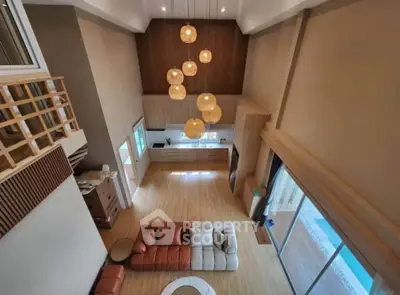 Stunning open-plan living room with high ceilings and modern kitchen in a luxurious home.