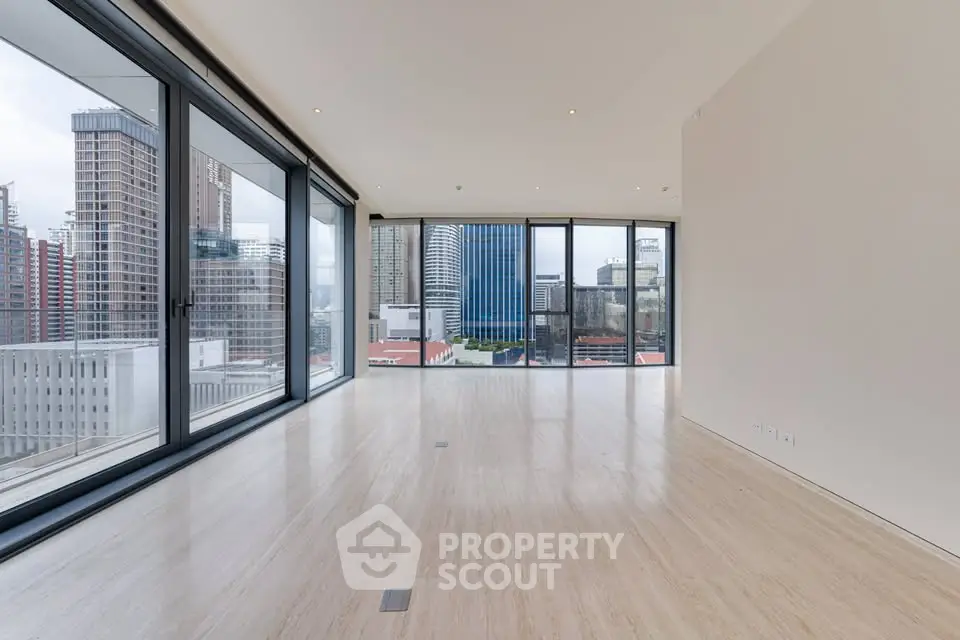 Spacious modern living room with floor-to-ceiling windows and city view