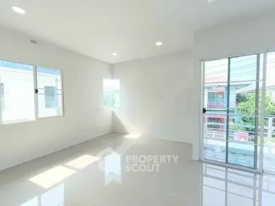 Bright and airy empty room with large windows and balcony access, perfect for customization.