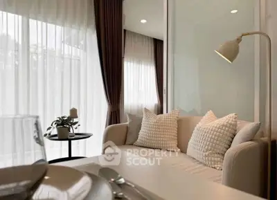 Elegant living room with cozy sofa and stylish decor, featuring soft lighting and modern design.
