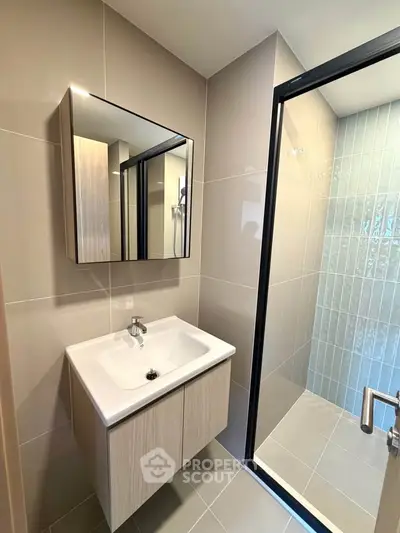 Modern bathroom with sleek vanity and glass shower enclosure