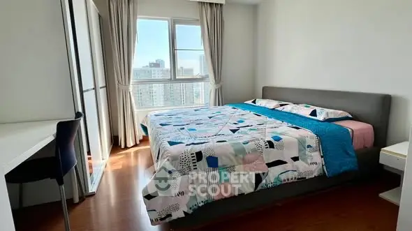 Bright and cozy bedroom with city view and modern decor.