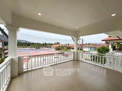 Spacious balcony with scenic view in a modern residential area, perfect for relaxation and outdoor activities.