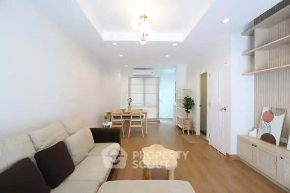 Spacious modern living room with stylish furniture and wooden flooring