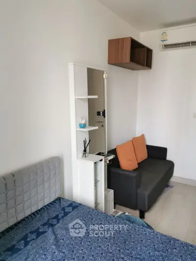 Cozy bedroom with modern decor and compact living area