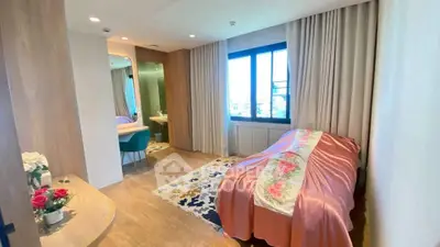 Charming bedroom with elegant decor and natural light, featuring a cozy bed and stylish ensuite bathroom.