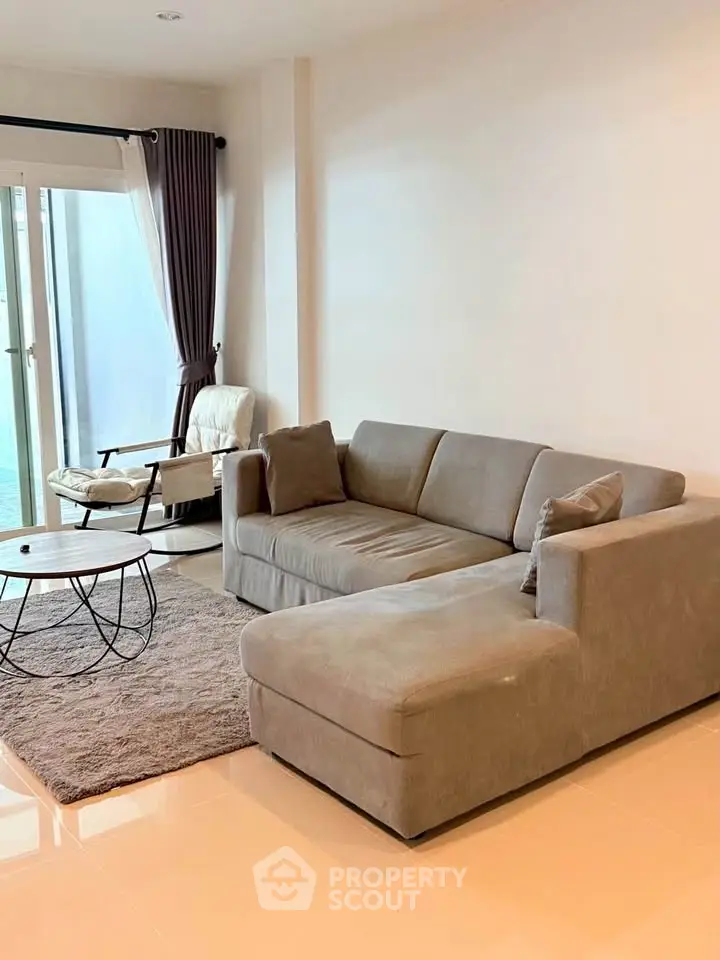 Modern living room with cozy sectional sofa and stylish decor, perfect for relaxation and entertaining.