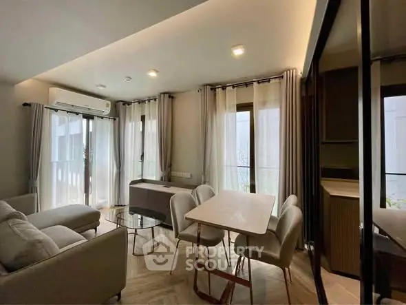 Modern living room with elegant dining area and natural light
