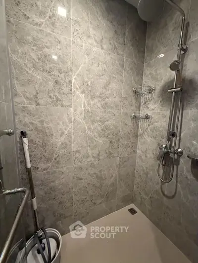 Modern bathroom with sleek marble tiles and rainfall showerhead