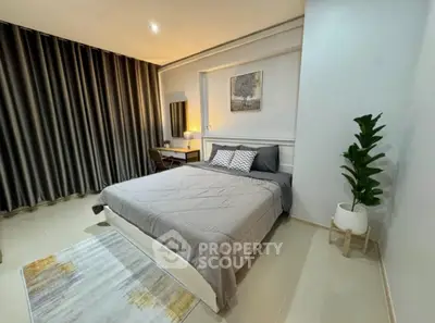Modern bedroom with stylish decor and cozy ambiance, featuring a comfortable bed and elegant furnishings.