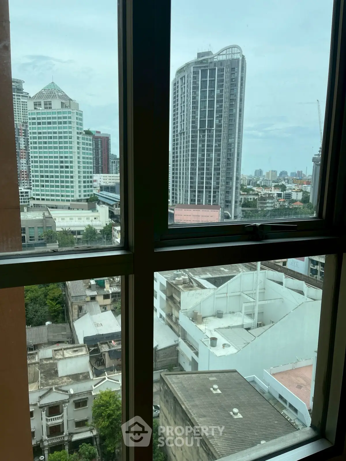 Stunning cityscape view from high-rise apartment window in urban setting.