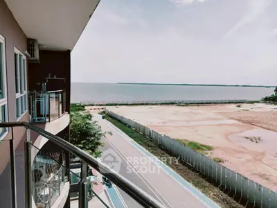 Stunning balcony view overlooking serene waterfront and open landscape.