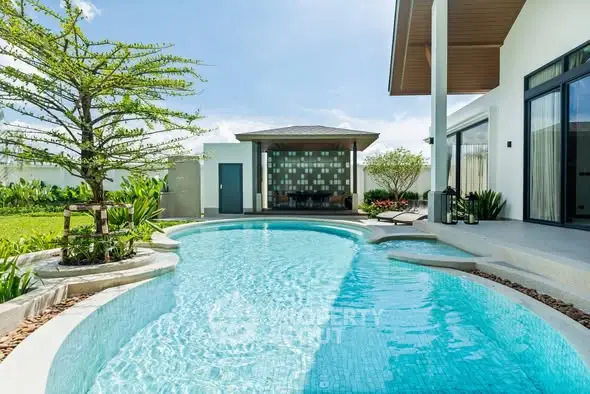 Luxurious modern villa with stunning private pool and lush garden, perfect for relaxation and entertainment.