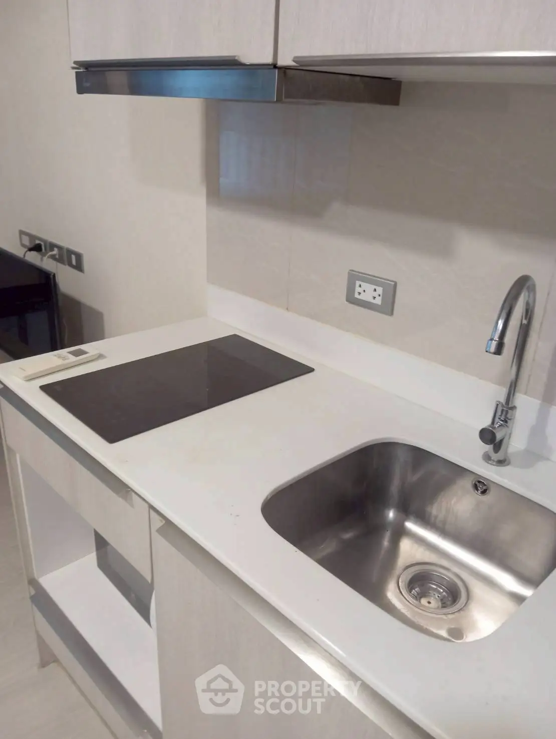 Modern kitchen with sleek countertop and built-in electric stove