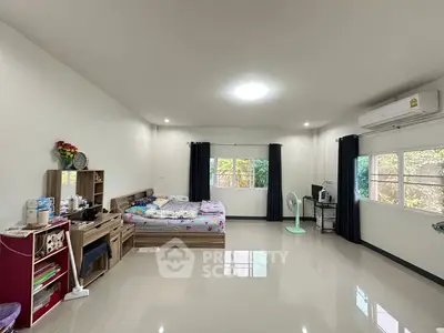 Spacious bedroom with modern decor and natural light