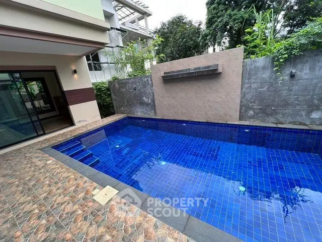 Luxurious private pool area with modern design and lush greenery