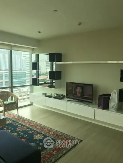 Modern living room with city view, stylish shelving, and cozy seating area.