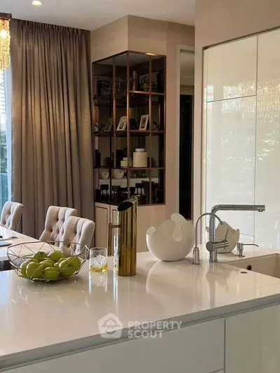 Luxurious modern kitchen with elegant decor and open layout, featuring a stylish dining area and ample natural light.