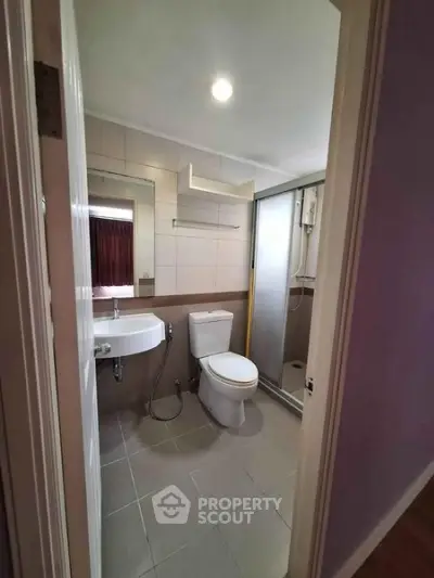Modern bathroom with sleek fixtures and glass shower enclosure