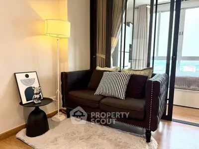 Cozy living room with stylish sofa, floor lamp, and decorative accents in modern apartment.