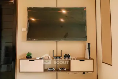 Modern living room with wall-mounted TV and sleek entertainment console