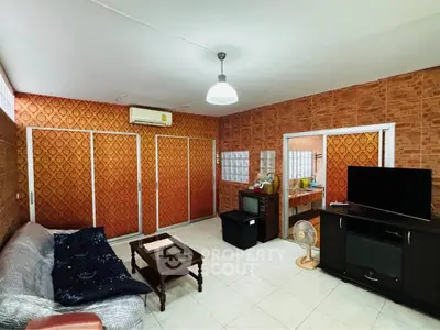 Spacious living room with vintage wallpaper and modern amenities