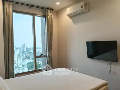 Modern bedroom with city view, featuring large window, wall-mounted TV, and air conditioning.