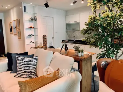 Modern open-layout living room with stylish kitchen and cozy seating area.