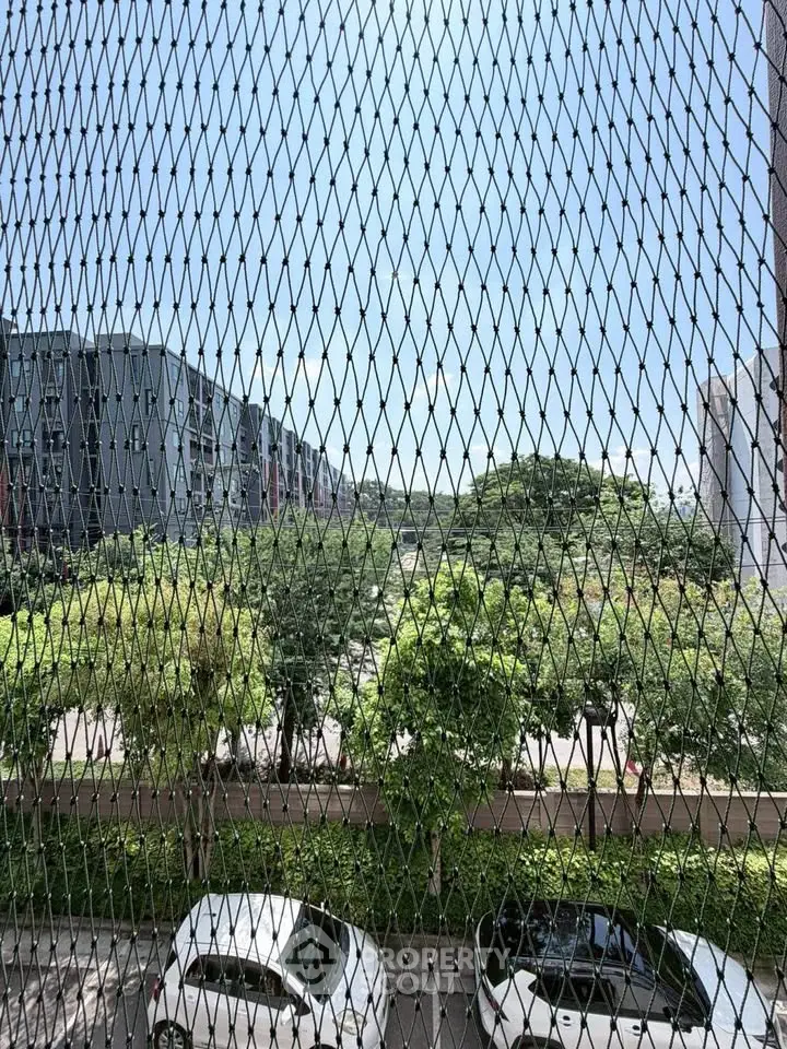 Scenic view from balcony with lush greenery and modern buildings
